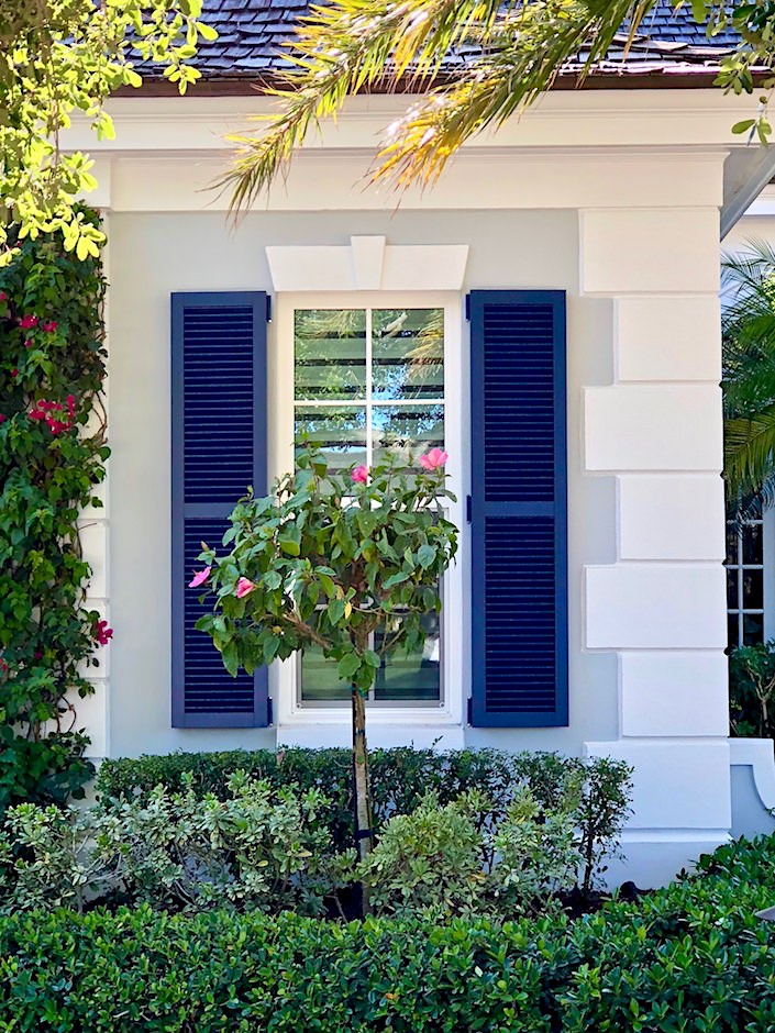 blue shutters against gray Florida exterior