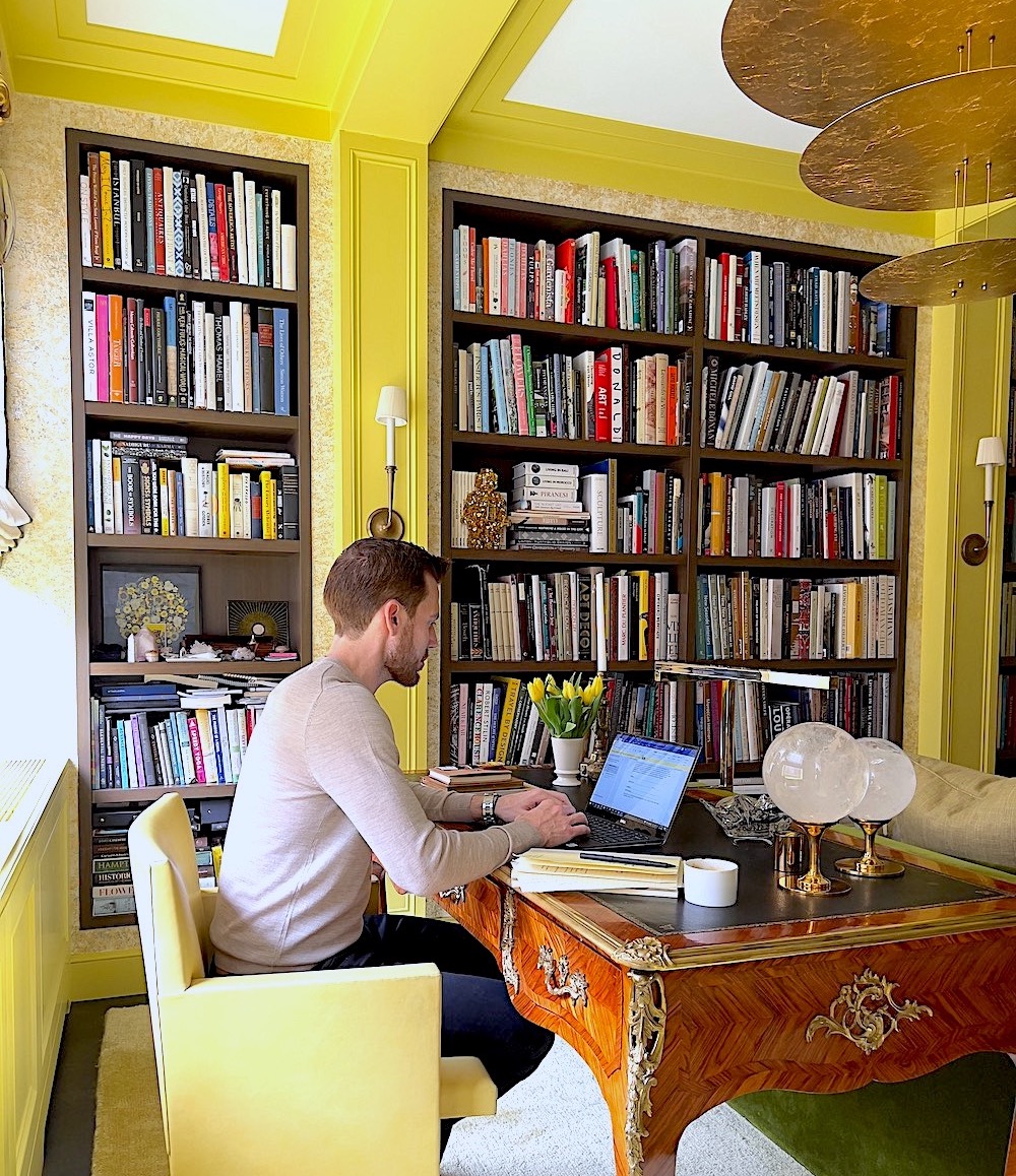 Caleb Anderson in his vibrant yellow home office